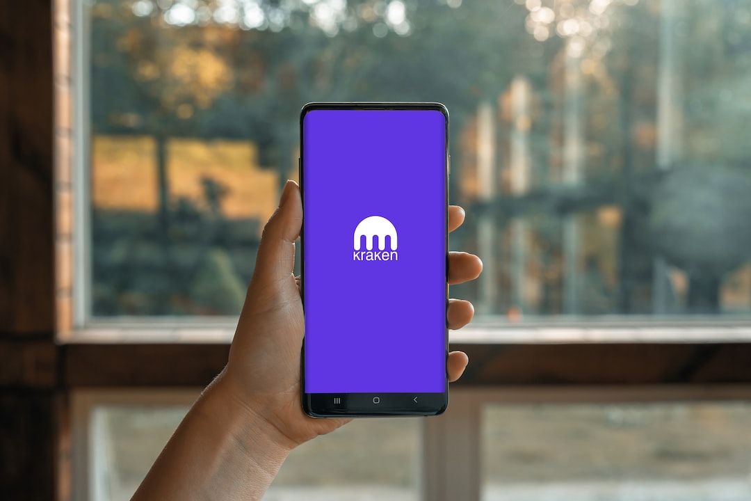 a hand holding a cell phone - Kraken Crypto App
, tags: provide user irs tax - unsplash